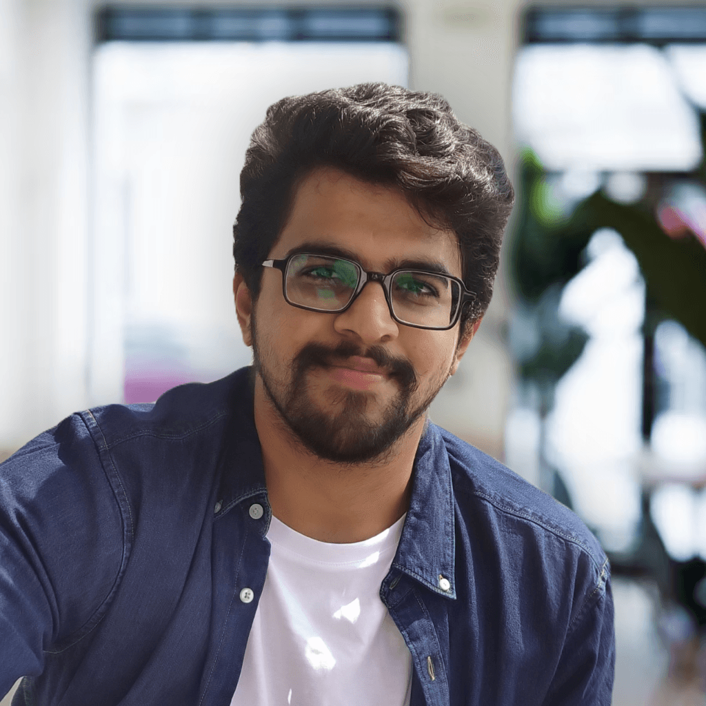 Deepak Nayak smiling in a blue shirt.